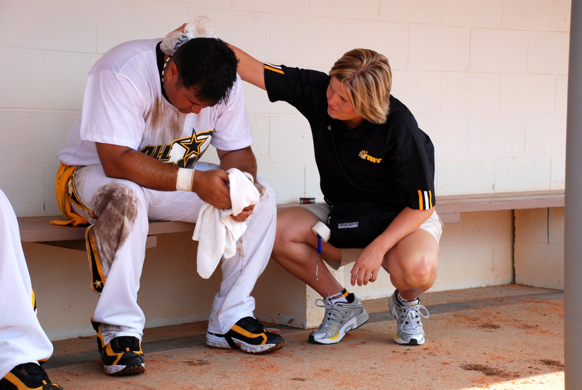 EGLIN AIR FORCE BASE, Fla. -- Michael Dochwat, Ft. Campbell, Ky., gets an ice pack for his neck from Noelle Tiner, team trainer, after diving for a ball during a game against the all-Marine Corps team. The 2007 U.S. Armed Forces Men's Softball Championship tournament, featuring the best players from the U.S. Air Force, U.S. Army, U.S. Marine Corps and the U.S. Navy, played the round-robin tournament Sept. 12 - 14 at Foster Stadium here. The all-Army team claim the gold medal while the Marine Corps sqeauked past the Air Force for the Silver. The all-Air Force team has won three championships in a row and four out of the last five. The all-Army team won it in 2003. (U.S Air Force photo by Staff Sgt. Mike Meares)