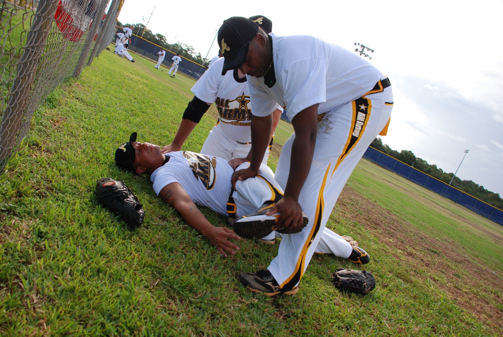 EGLIN AIR FORCE BASE, Fla. -- Lee Diaz, all-Army second baseman from Ft. Meade, Md., gets help stretching by Jacob Jenkins before their first game against all-Marine Corps at the 2007 U.S. Armed Forces Men's Softball Championship tournament Sept. 12 - 14 at Foster Stadium here. The annual tournament features the best players from the U.S. Air Force, U.S. Army, U.S. Marine Corps and the U.S. Navy, in a 18-game round-robin tournament. The all-Army team claim the gold medal while the Marine Corps sqeauked past the Air Force for the Silver. The all-Air Force team has won three championships in a row and four out of the last five. The all-Army team won it in 2003. (U.S Air Force photo by Staff Sgt. Mike Meares)