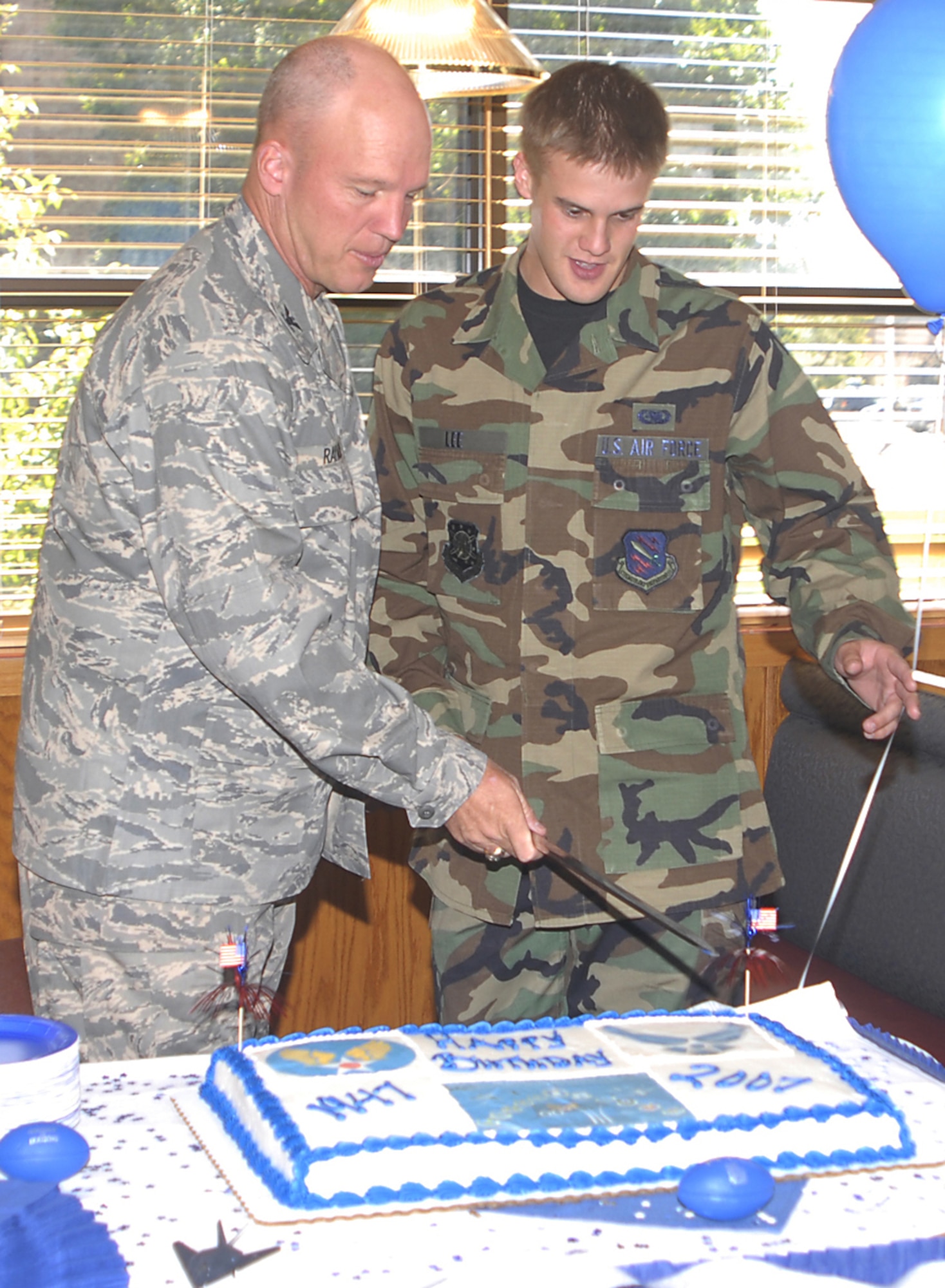 Col. Jay Raymond, 21st Space Wing commander, and Airman Michael Lee, 21st Logistics Readiness Squadron, cut the Air Force’s ceremonial birthday cake Sept. 18 at the Aragon Dining Facility. The Air Force marks its 60th birthday this year. (U.S. Air Force photo)
