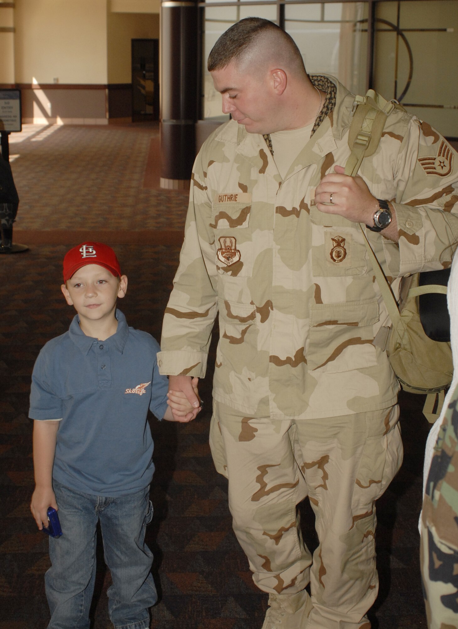 Staff Sgt. Ryan Guthrie greets his family at the Colorado Springs Airport Sept. 14. Sergeant Guthrie was one of 12 members of the 21st Security Forces Squadron returning from a six-month deployment in Iraq. (U.S. Air Force photo by Larry Hulst)
