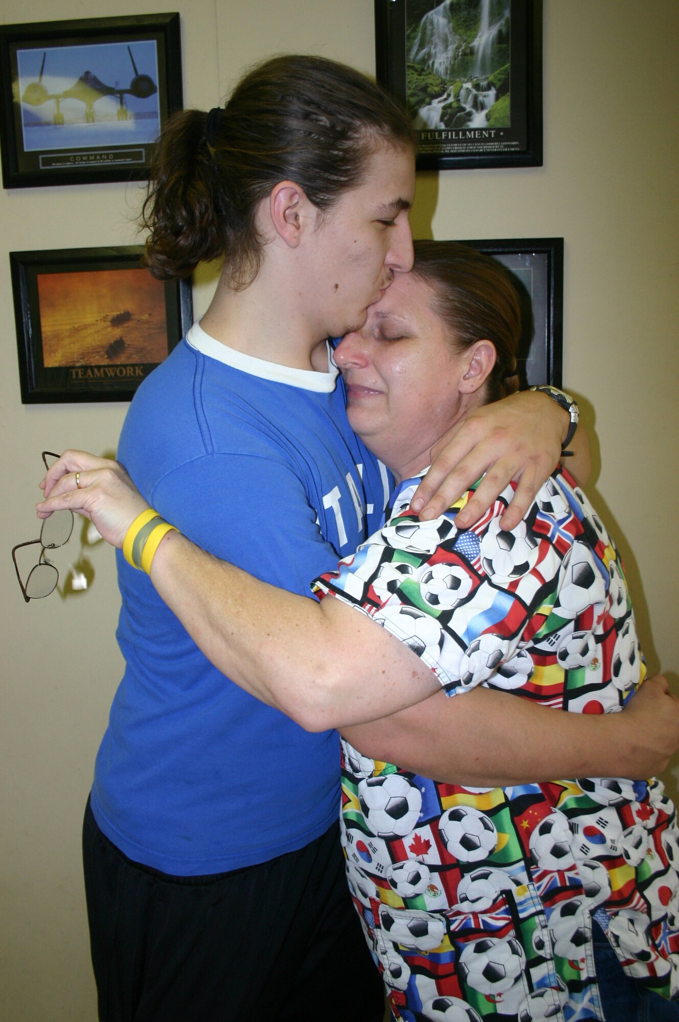 Suzy Haudenshild, 82nd Mission Support Group, receives a hug and kiss from her son, Nicholas.  A telephone conversation between Mrs. Haudenshild and Adrian Sibayan, 82nd Medical Support Squadron, saved Nicholas’s life Aug. 9 when he suffered a cardiac arrest. (U.S. Air Force photo/Staff Sgt. Tonnette Thompson)