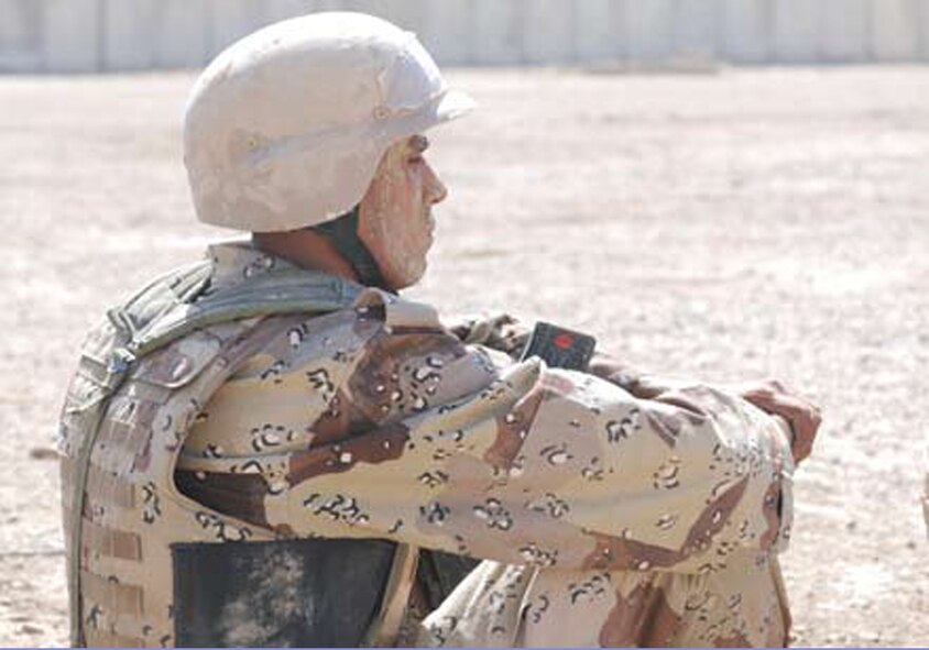 AR RUSTAMIYAH, Iraq - Dried mud, covering the face and helmet of an IMAR cadet, serves as an improvised form of camouflage. During the junior term’s first field exercise, students learn the basics of living and surviving in a field environment. (U.S. Air Force photo / Senior Airman Christie Putz)