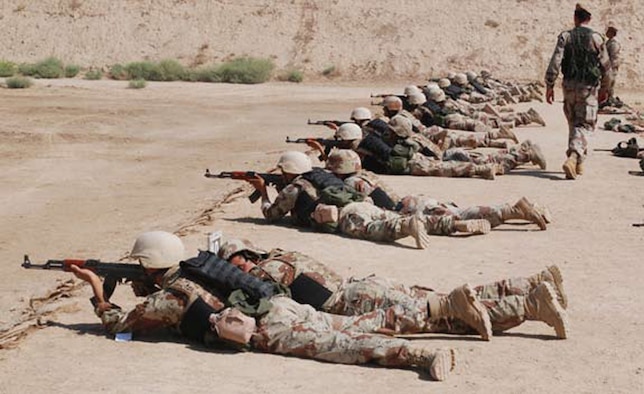 AR RUSTAMIYAH, Iraq - Senior term cadets practice their marksmanship and leadership skills during a course at the IMAR firing range. One student coached, while the other fired. (U.S. Air Force photo / Senior Airman Christie Putz)