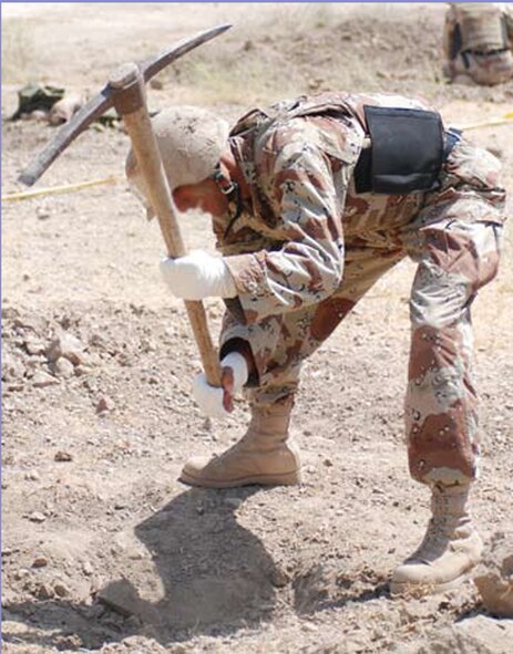 AR RUSTAMIYAH, Iraq - A junior-term cadet at Iraqi Military Academy Rustamiyah uses a pick-axe to dig a fighting position hole during his class’s first field exercise Sept. 4. Junior term teaches cadets basic infantry tactics and begins leadership training. (U.S. Air Force photo / Senior Airman Christie Putz)