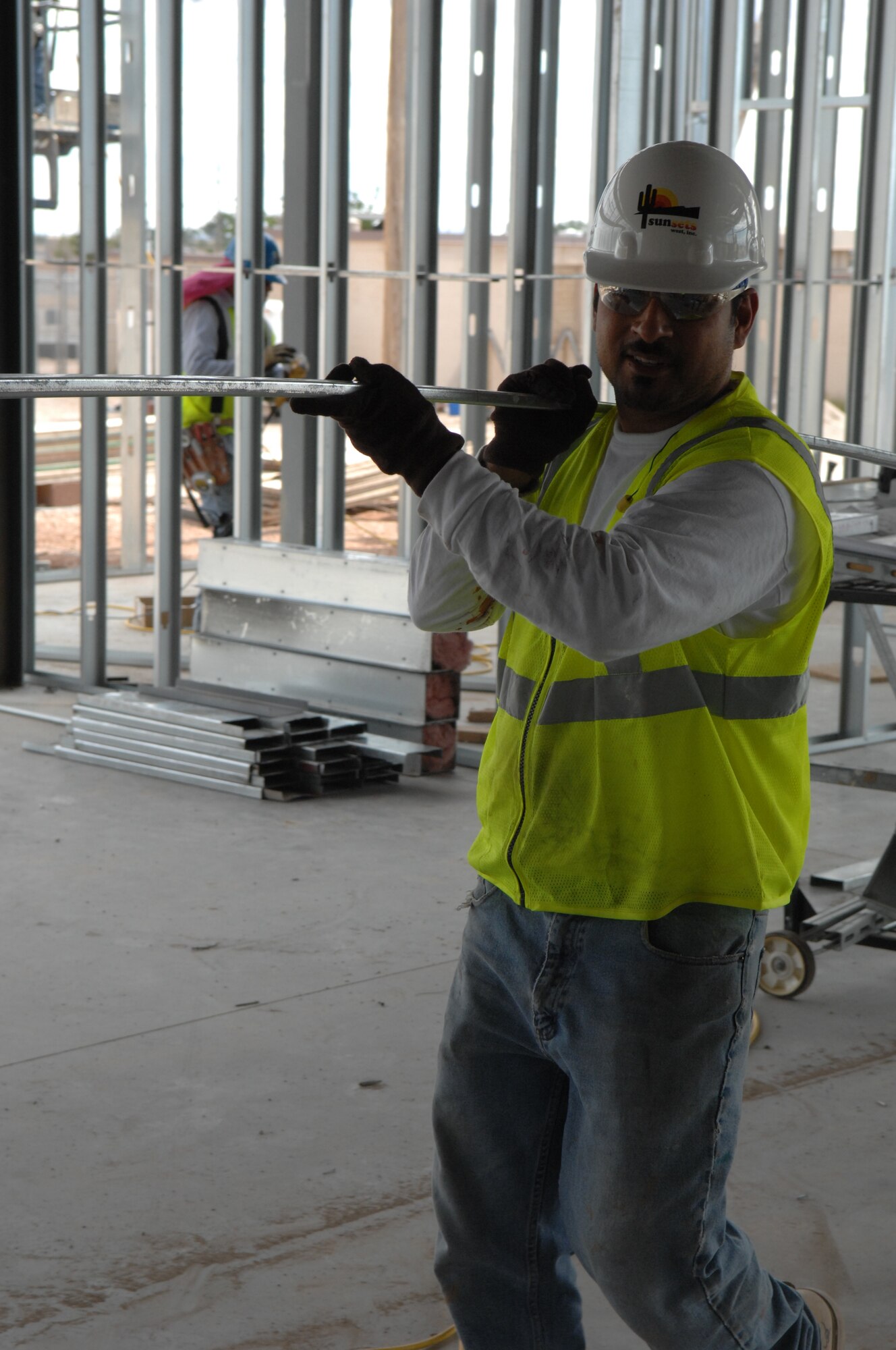 Mr. Juan Camacho, framing crew member of the Urban
Association of El Paso, Texas, carries frames to another location in the
firehouse. (U.S. Air Force photo by Senior Airman Anthony Nelson)