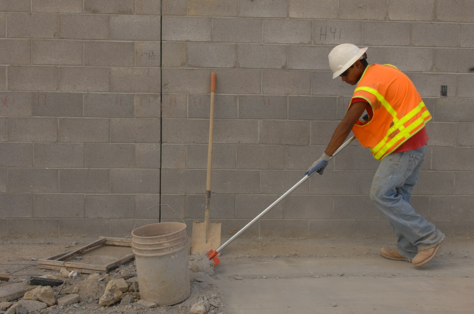 Mr. Robert Madera, member of the safety team from Urban
Association of El Paso, Texas, shovels debris at the construction site.
(U.S. Air Force photo by Senior Airman Anthony Nelson)