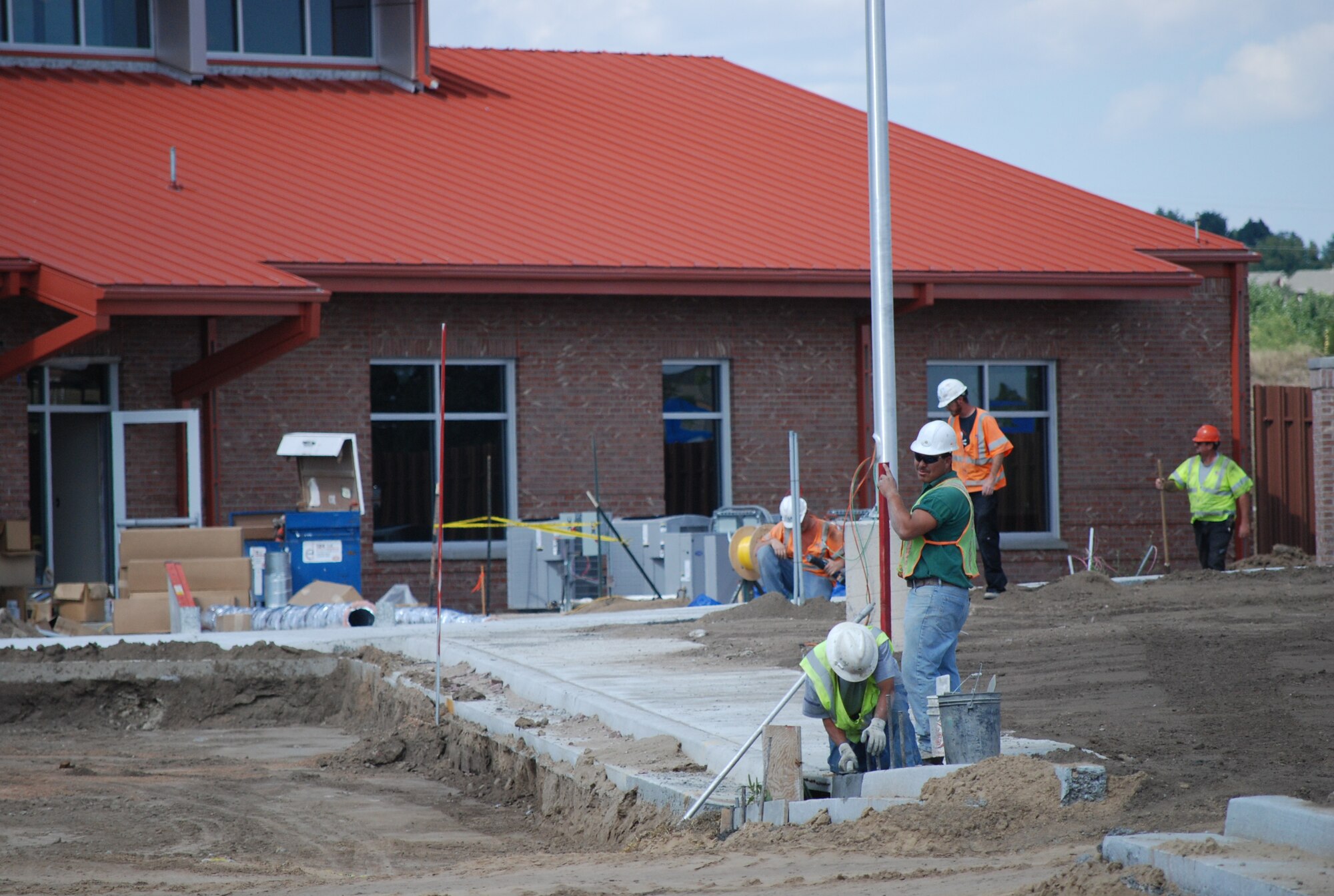 Construction continues in earnest at the West Gate; the re-opening ceremony is slated for Nov. 5. The visitors center and gate house are nearly complete, while work goes on with the landscaping, street lights, bridge and paving the new road. (U.S. Air Force photo by Steve Brady)