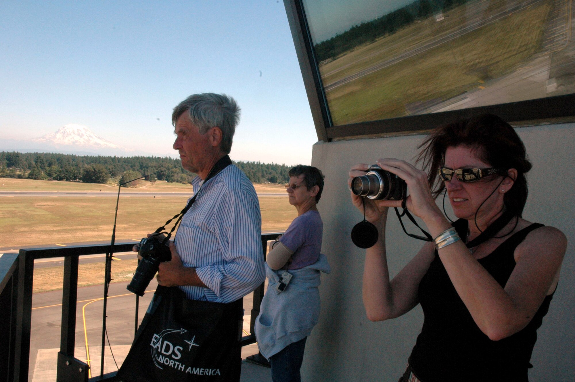 Artists James Consor, Priscilla Messner-Patterson and Christine Murphy take reference photos July 25 during a visit to McChord Air Force Base, Wash., for the Air Mobility Rodeo 2007. The artists are with the Air Force Art Program and will use the photos to document Air Force activities through paintings and other media. (U.S. Air Force photo/Tech. Sgt. Scott T. Sturkol) 