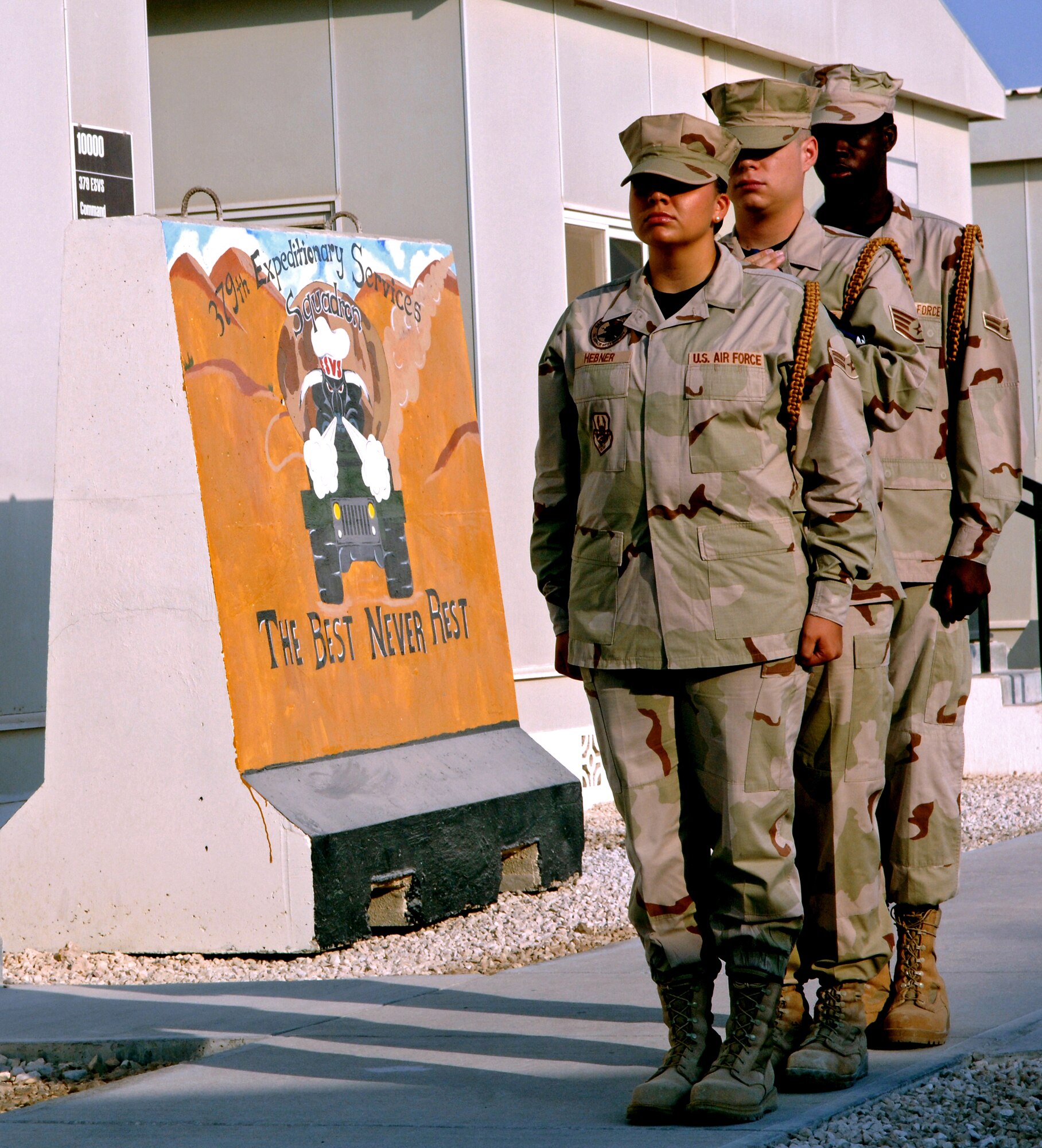 SOUTHWEST ASIA -- Airman 1st Class Evon Hebner (front), Staff Sgt. Christopher McDonald (middle) and Airman 1st Class Miguel Leon (back), 379th Air Expeditionary Wing Honor Guard prepare for a reveille ceremony here Tuesday in honor of the Air Force 60th Anniversary. The 379th AEW began a week long celebration beginning Sept. 12 that included fitness related events and specials at Army and Air Force Exchange concessionaires. (U.S. Air Force photo/Master Sgt. Greg Kunkle)