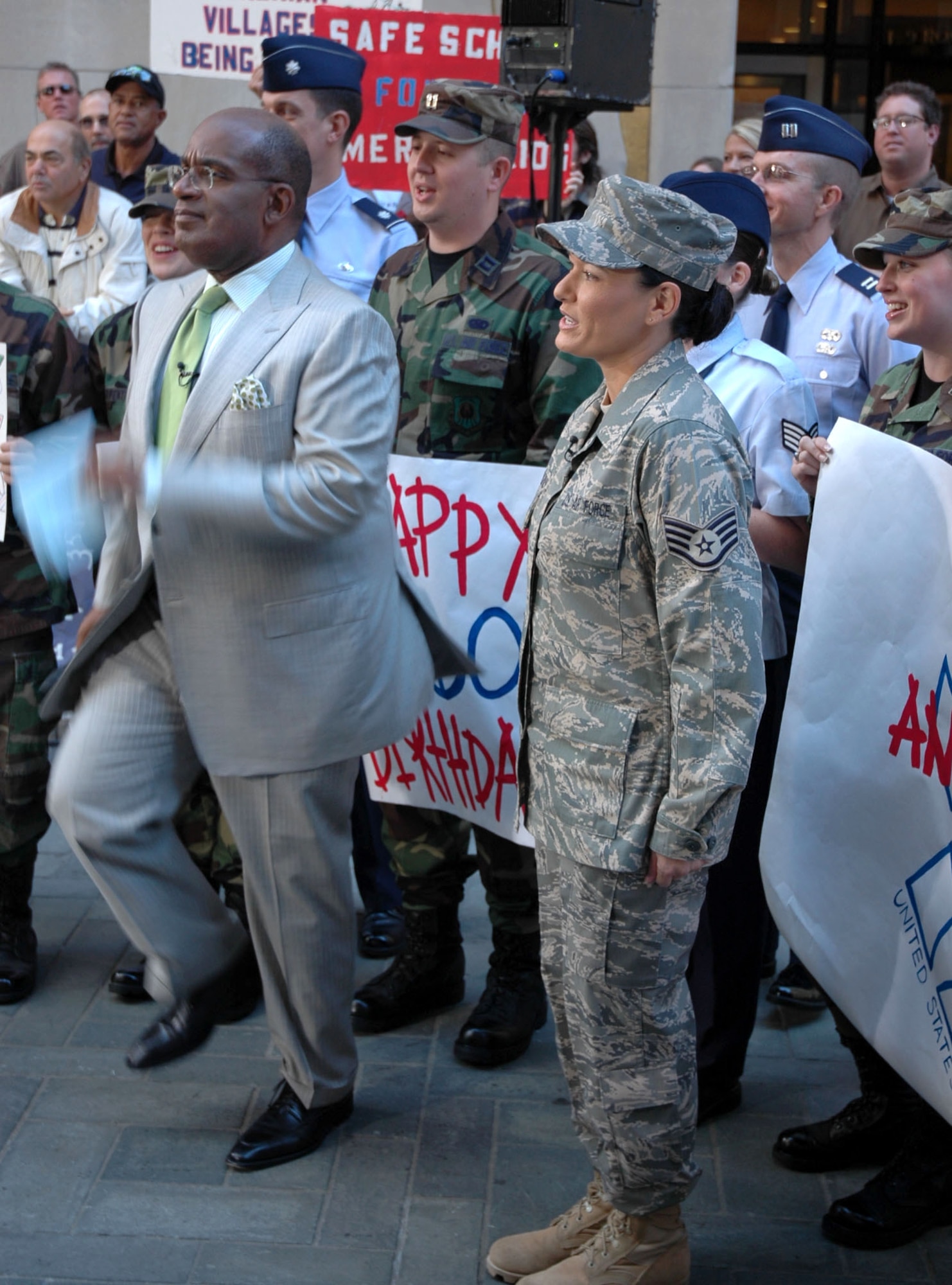 "Today" show weatherman Al Roker marches to an impromptu rendition of the "Air Force Song" with Airmen Sept. 18 in Rockefeller Plaza in New York City. Mr. Roker offered the service congratulations in front of millions of viewers. (U.S. Air Force photo/Maj. John Thomas) 
