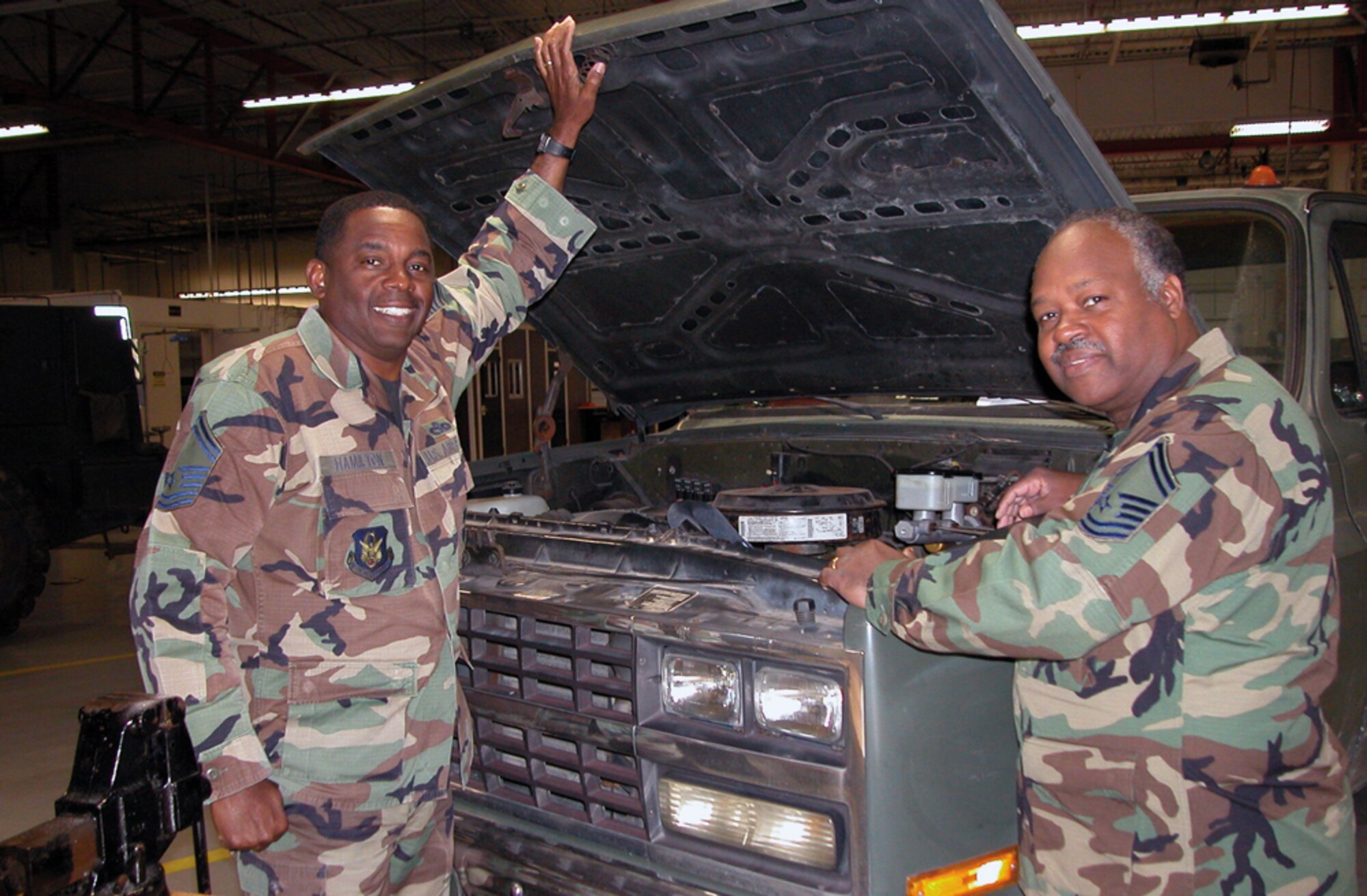 Senior Master Sgt. Donald Hamilton (left), superintendent, vehicle operations and Senior Master Sgt. Donald McCutcheon, superintendent, vehicle maintenance take a final look under the hood of a transportation assigned truck. Both of these veteran NCOs recently retired from the 403rd Logistics Readiness Squadron. (U.S. Air Force Photo/Master Sgt. Cecil Burch)