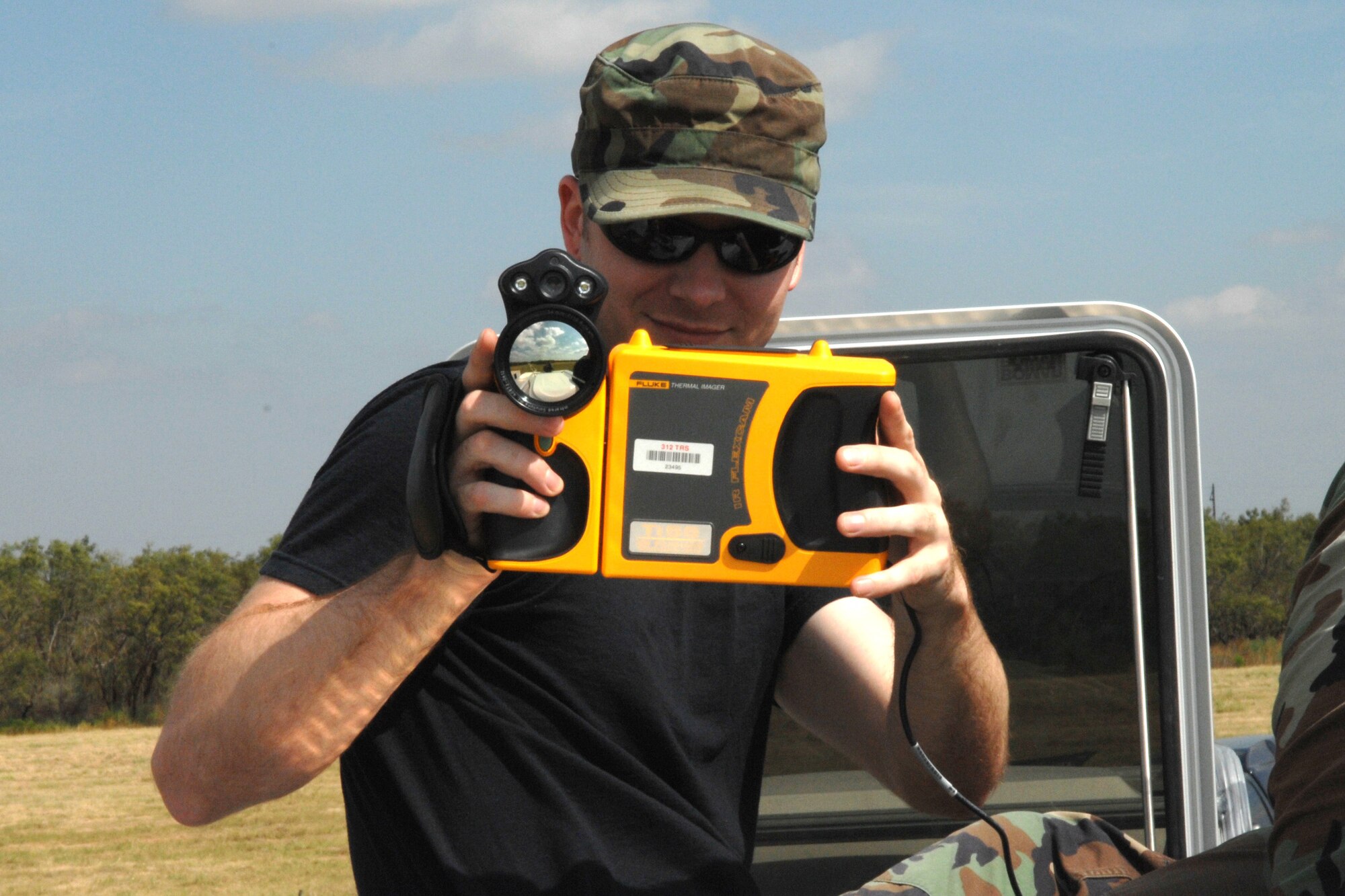 DYESS AIR FORCE BASE, Texas - Senior Airman Kristopher Craw, from the 312 Training Squadron in Goodfellow AFB, takes thermal photos of the 7th Civil Engineer Squadron's explosions September 17. 
The 312 TRS came to Dyess to experiment with new equipment they could not use at their base. (U.S. Air Force photo by Airman 1st Class Jennifer Romig)