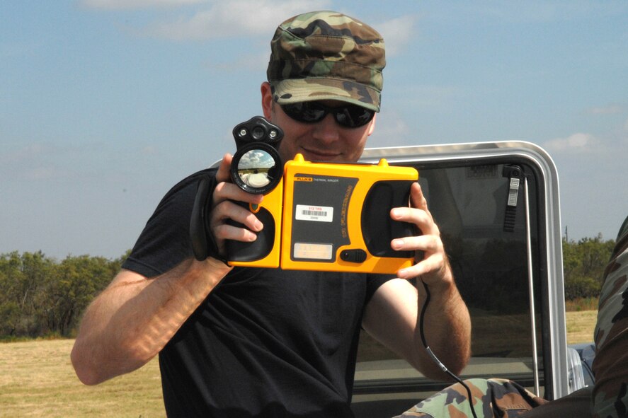 DYESS AIR FORCE BASE, Texas - Senior Airman Kristopher Craw, from the 312 Training Squadron in Goodfellow AFB, takes thermal photos of the 7th Civil Engineer Squadron's explosions September 17. The 312 TRS came to Dyess to experiment with new equipment they could not use at their base. (U.S. Air Force photo by Airman 1st Class Jennifer Romig)