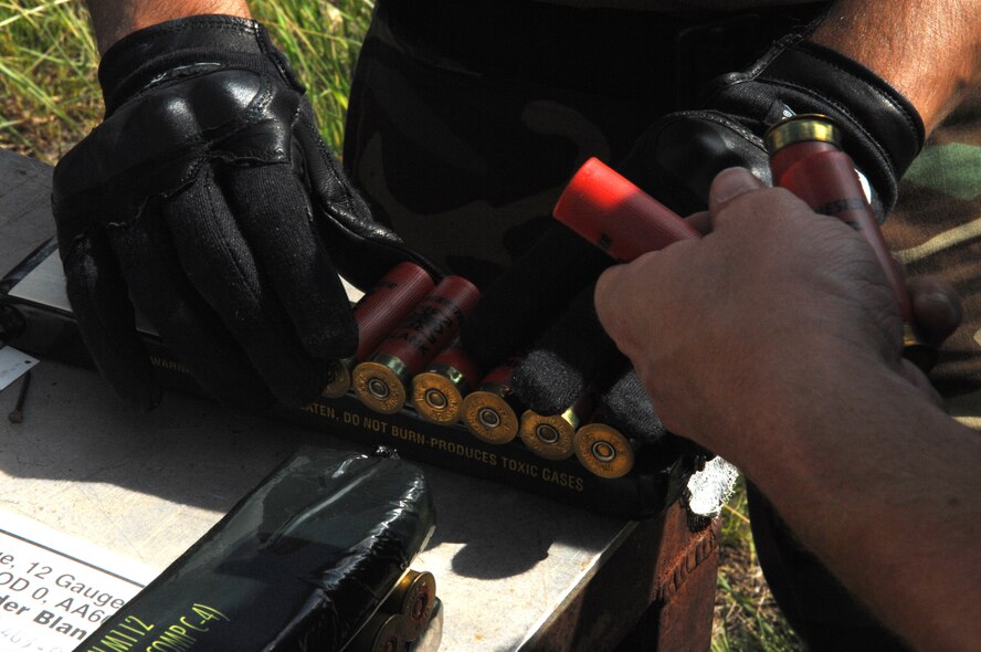 DYESS AIR FORCE BASE, Texas - Senior Airman Erik Durantt from the 7th Civil Engineer Squadron places old, unused shot gun shells to more explosives for testing purposes . (U.S. Air Force photo by Airman 1st Class Jennifer Romig)