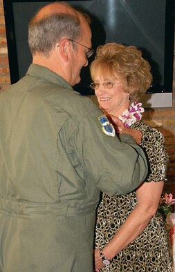 Brig. Gen. Richard Moss pins Ann Kranz, at her retirement ceremony in June. Mrs. Kranz completed 36 years of federal service, of which 19 were served with the 403rd Wing. Family and friends joined her at Vrazels restaurant to celebrate and show appreciation for her hard work and dedication. She was awarded the Outstanding Civilian Career Service Award by General Moss and received a letter of appreciation from the Department of the Air Force signed by President George W. Bush. This marks the end of a more than remarkable career. Mrs. Kranz began her federal service career at the Keesler Commissary in 1971 and quickly excelled leading to several promotions at 81st Medical Center and other agencies on the base. She first worked for the 403rd Tactical Airlift Wing as a budget analyst in 1991 and left the Wing for two years from 1998-2000 to serve at Headquarters, Pacific Air Force, Hickam Air Force Base, Hawaii. Since returning, she spent her last seven years with the 403rd as the Financial Analysis Officer where she held great responsibilities. "I?ve kept a job since I got out of high school and never really had quality time. Now, I get to spend time with my family and visit with friends for lunch with no worries about limited time," said Mrs. Kranz. "I?ve always enjoyed reading and I?ve been able to just kick back and read book." She and her husband, Michael, are currently gearing up for a cruise on the Queen Mary II. (U.S. Air Force Photo/Senior Airman Tabitha Spinks)