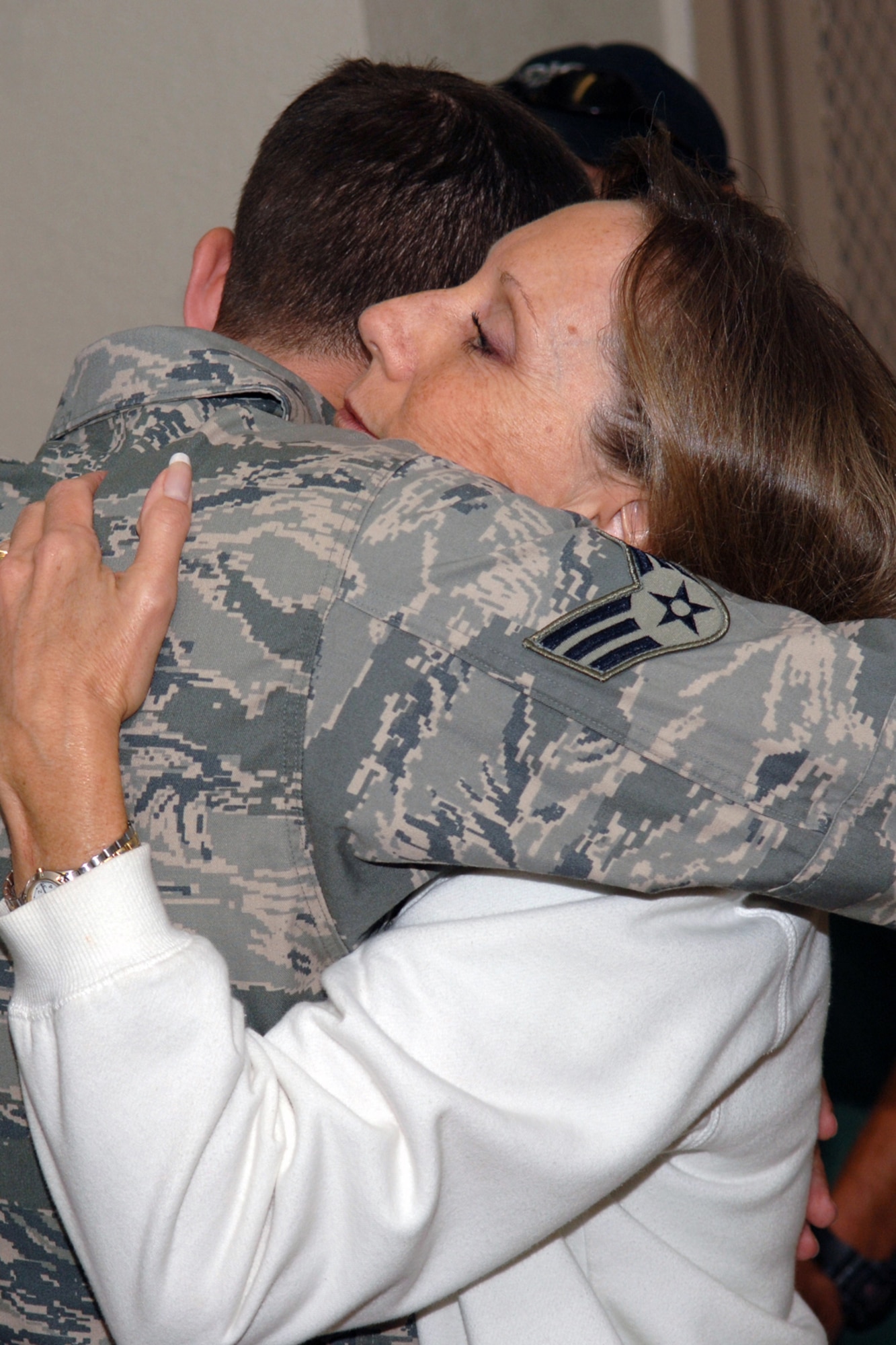 DYESS AIR FORCE BASE, Tx.-- U.S. Air Force Senior Airman Wade Isham hugs his mother at the 7th Securtiy Forces Armory before his deployment on Sept. 14, 2007. (U.S. Air Force Photo by Airman First Class Micheal S. Breaux)