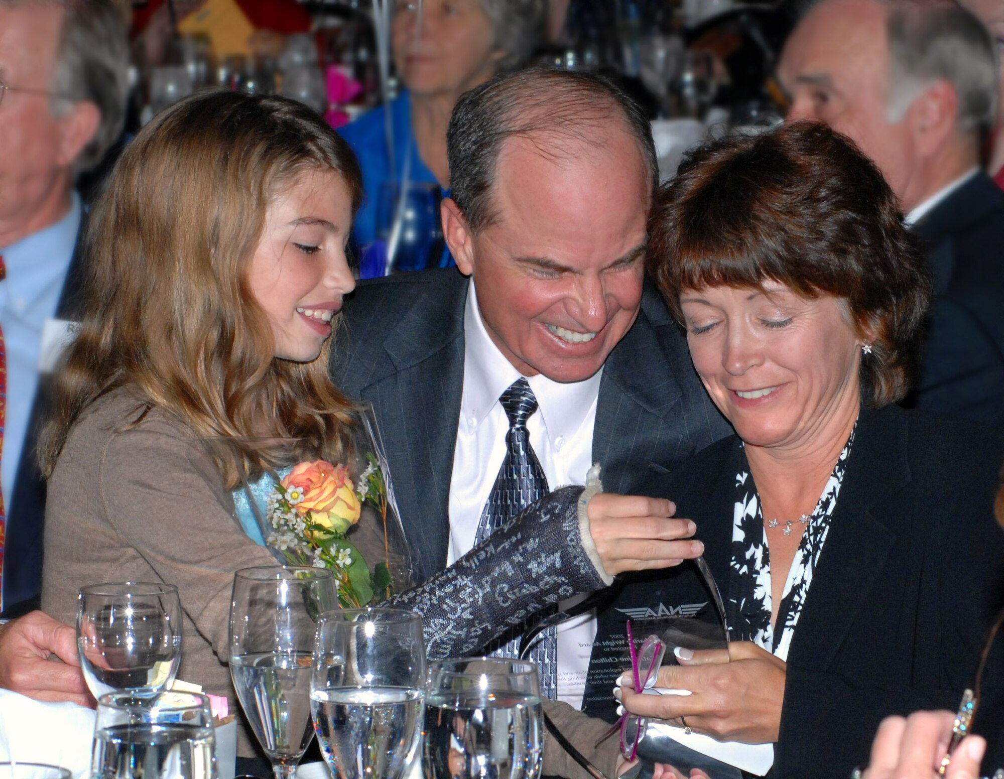 Col. Catherine A. Chilton shares a celebratory moment with her husband Gen. Kevin P. Chilton and their daughter, Morgan, Sept. 15 at at a conference of the Ninety-Nines in Boulder, Colo. Colonel Chilton was named the National Aeronautic Association's Katharine Wright Award winner during the conference. The colonel is the senior mobilization assistant to the commander of Air Force Research Laboratory. Her husband, General Chilton, is the Air Force Space Command commander. (U.S. Air Force photo by Duncan Wood)