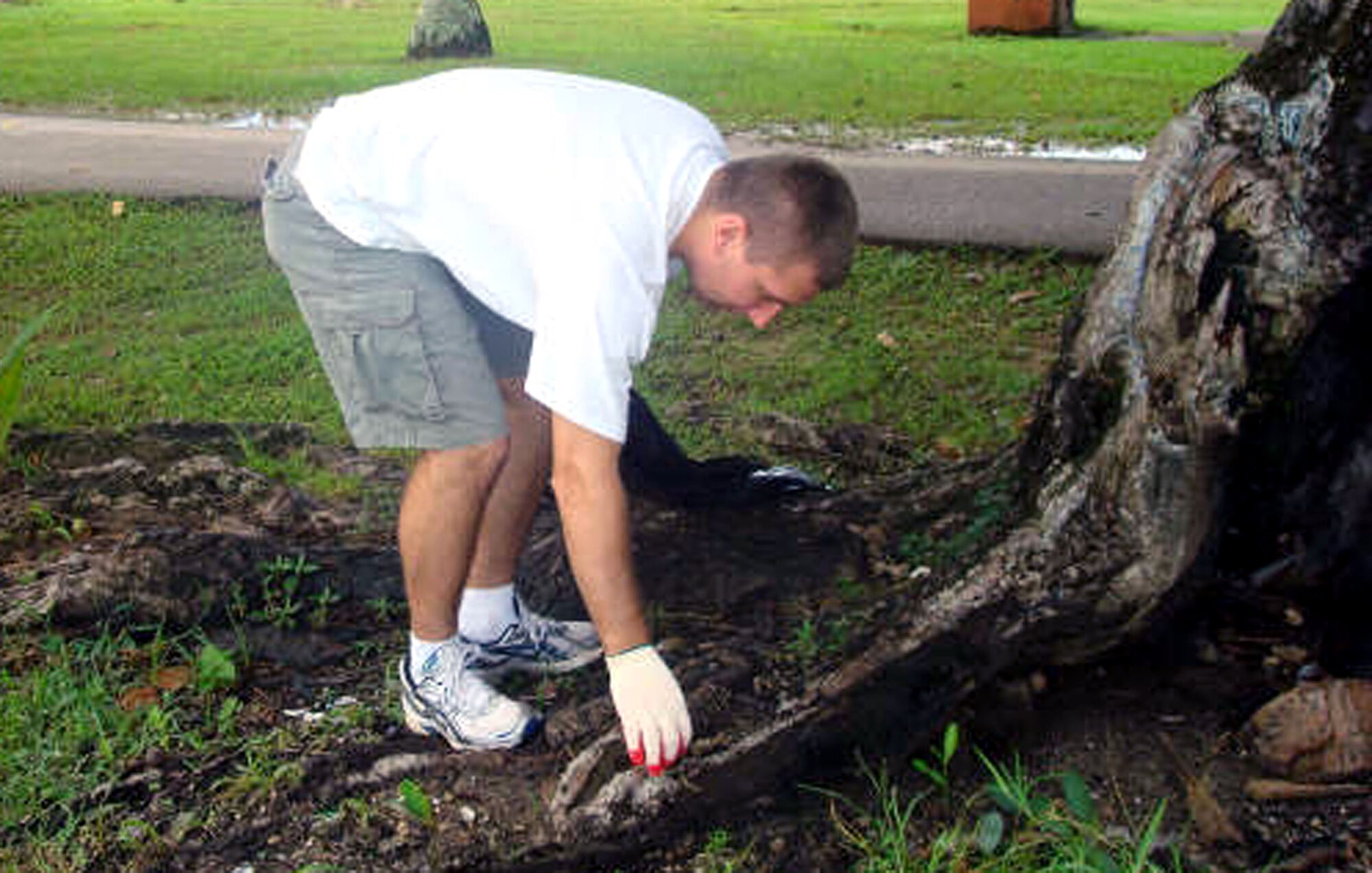 1st Lt. Andrew Smeckert picks up trash Sept. 15 during Guam's 13th annual coastal cleanup. The event is geared toward preserving the island's natural beauty. Deployers and permanent party members from Andersen Air Force Base, Guam, participate in the cleanup each year. (U.S. Air Force photo/1st Lt. Tiffany Bares)