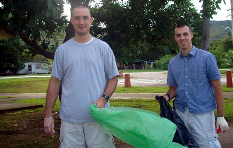 Capt. Ken Hills (right) and 1st Lt. Ben Poole participate Sept. 15 in the annual coastal cleanup in Guam. Both are currently deployed to the 20th Expeditionary Bomb Squadron at Anderson Air Force Base, Guam. Eight members of the unit volunteered to spend their off-duty time assisting the local populace during the annual event geared toward preserving the island's natural beauty. (U.S. Air Force photo/1st Lt. Tiffany Bares)