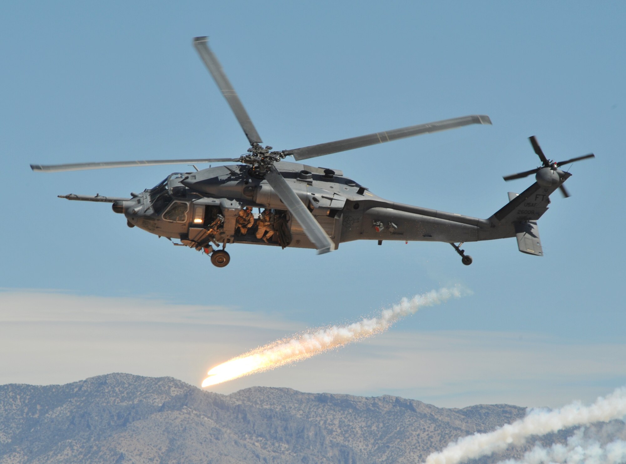 An HH-60G Pave Hawk, assigned to Nellis Air Force Base, Nev., fires off flares while demonstrating evasive maneuvers during the firepower demonstration held at the Nevada Test and Training Range, Sept. 14, 2007. The demonstration gives the public a close-up and realistic view into the Air Force's ability to perform its wartime mission.  
(USAF photo by Airman First Class Brian Ybarbo)
