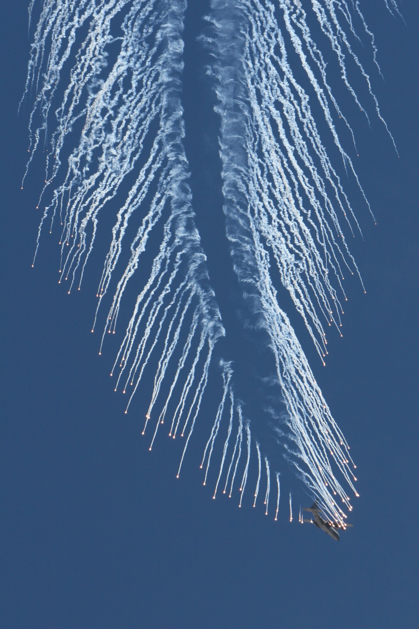 An AC-130 gunship executes an evasive maneuver and drops flares during the firepower demonstration held at the Nevada Test and Training Range, Sept. 14, 2007. The demonstration gives the public a close-up and realistic view into the Air Force's ability to perform its wartime mission.  
 (USAF photo by Lawrence Crespo) 
