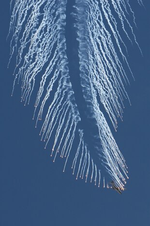 An AC-130 gunship executes an evasive maneuver and drops flares during the firepower demonstration held at the Nevada Test and Training Range, Sept. 14, 2007. The demonstration gives the public a close-up and realistic view into the Air Force's ability to perform its wartime mission.  
 (USAF photo by Lawrence Crespo) 
