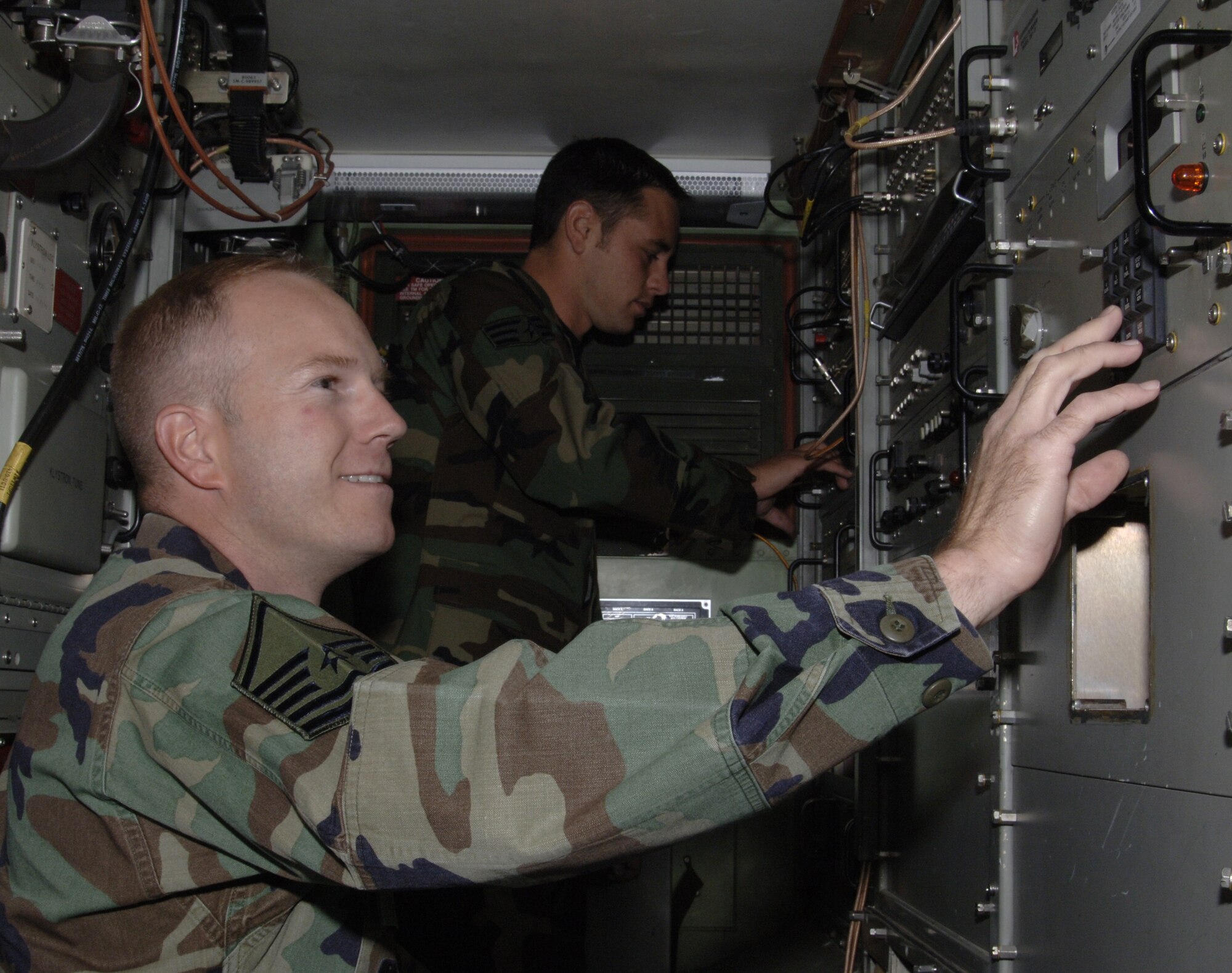 MOUNTAIN HOME AIR FORCE BASE, Idaho -- MSgt Thomas J. Keck, 726 ACS Maintenance Operations NCOIC, along with Senior Airman Brent Stensland program a satellite communications terminal to provide long haul communications for Airmen downrange. (U.S. Air Force Photo/ Staff Sgt. Rodney D. Ivey)