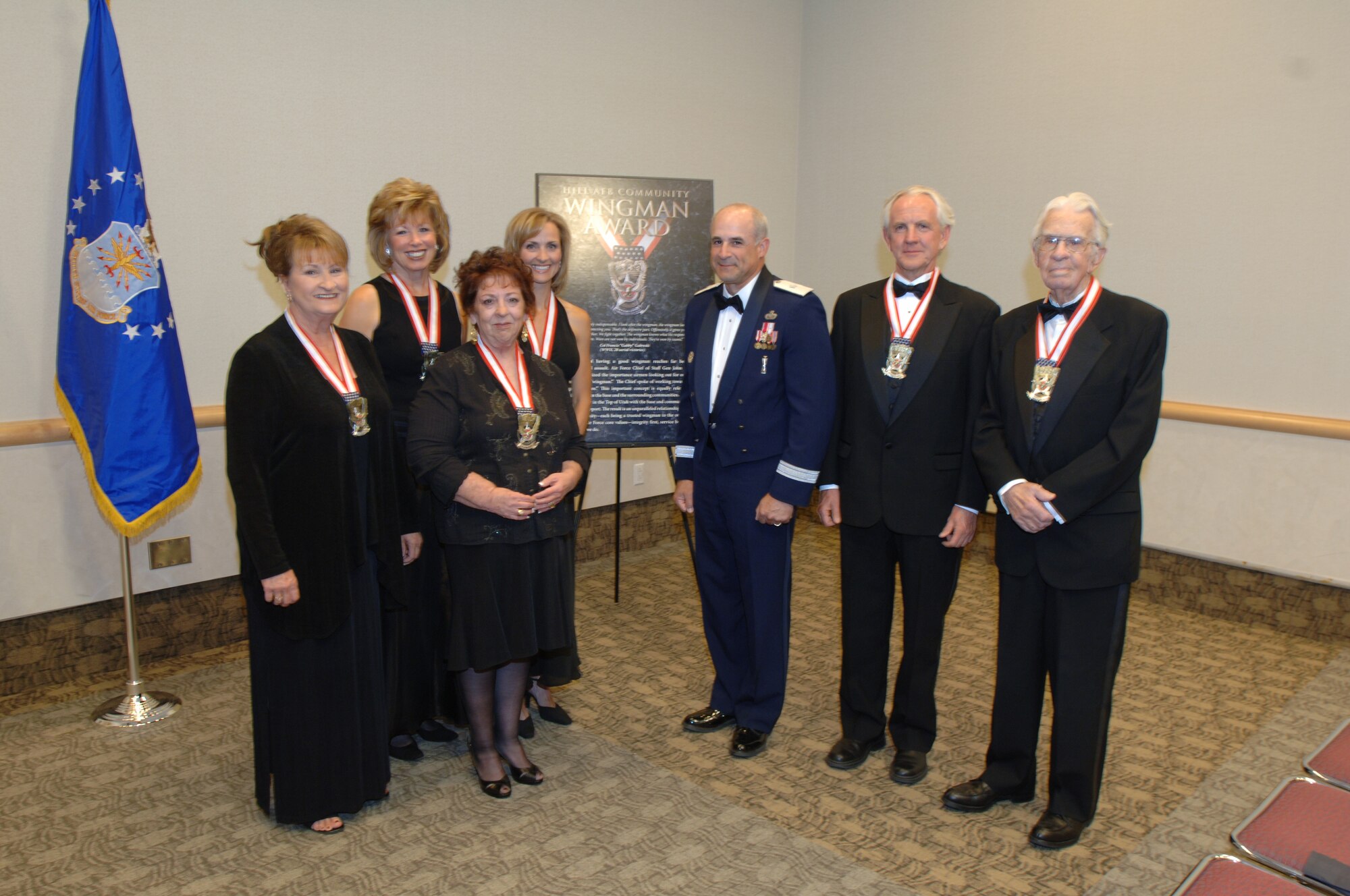 HILL AIR FORCE BASE, Utah-- (From left to right) Jewel Lee Kenley, Vickie McCall, Amy Mazer-Meighan, accepting on behalf of her father retired Col. Nate Mazer,  Karine Kucej, accepting on behalf of her father retired Lt. Gen. Marc Reynolds,  Brig. Gen. Ken Merchant, vice commander of the Ogden Air Logistics Center, retired Major Lynn Hadley, accepting on behalf of his father retired Maj. Gen. Rex Hadley, and John A. Lindquist Sr. (U.S. Air Force photo by Alex R. Lloyd)