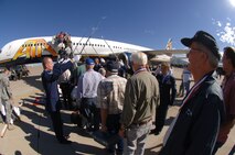 WWII veterans board the aircraft under a saber arch presented by the Hill Air Force Base honor guard. 