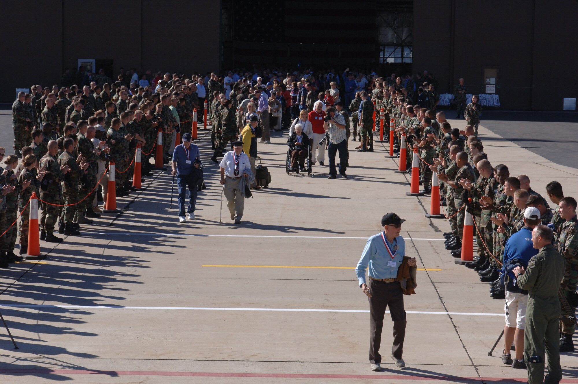 388th Fighter Wing members cheer on 130 WWII veterans as they walk to board the aircraft to take them to Washington D.C.