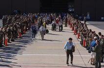 388th Fighter Wing members cheer on 130 WWII veterans as they walk to board the aircraft to take them to Washington D.C.