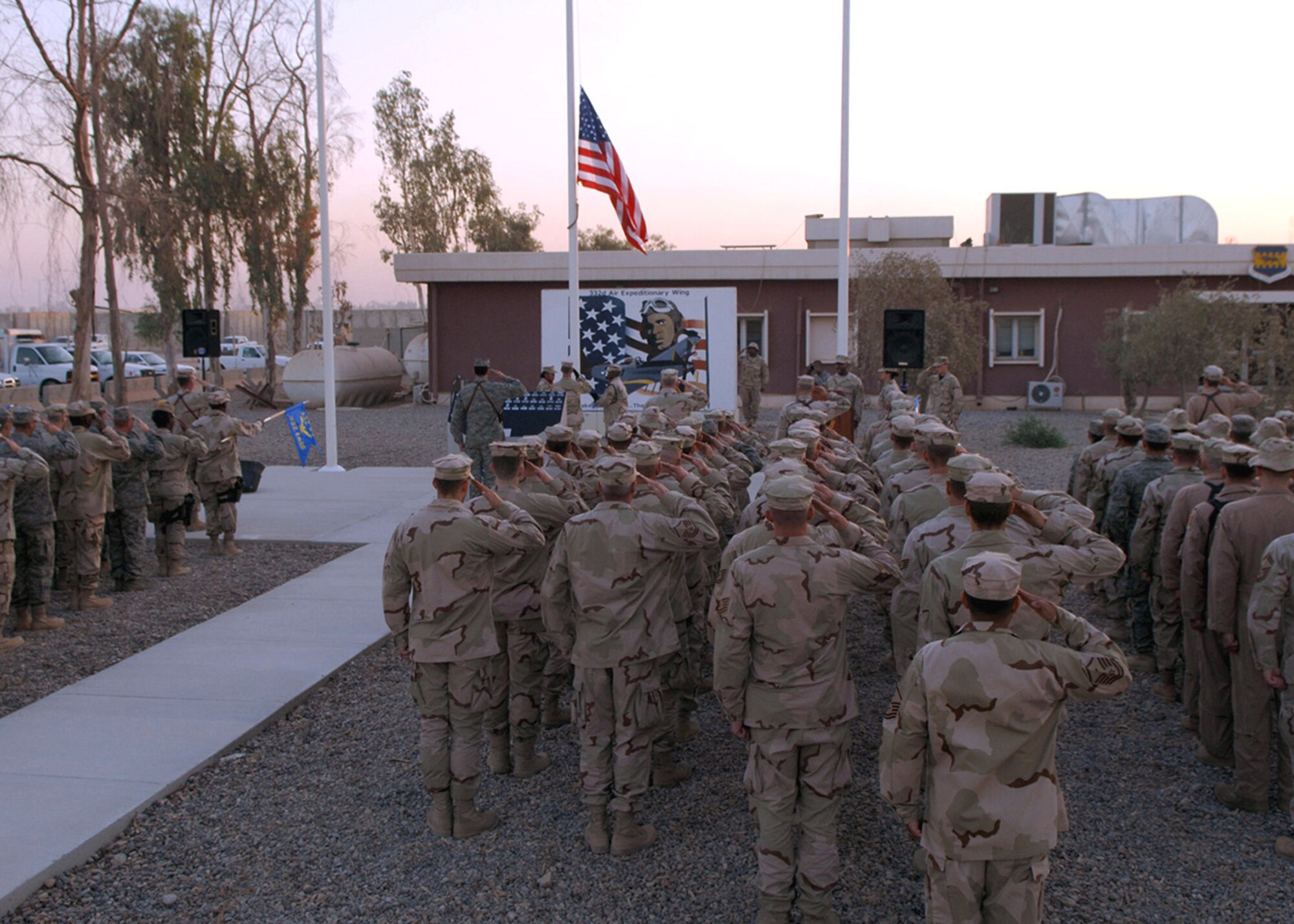 Tuskegee Airmen of the 332nd Air Expeditionary Wing salute the American flag during reveille Sept. 18 at Balad Air Base, Iraq. Members of the 332nd AEW, the most forward-deployed Air Force wing in Iraq, held the ceremony in observance of the Air Force's 60th birthday. The wing draws its heritage from the famed 332nd Fighter Group, led by the Tuskegee Airmen of World War II, and carries this spirit in operations here. (U.S. Air Force photo/Maj. John Sheets) 
