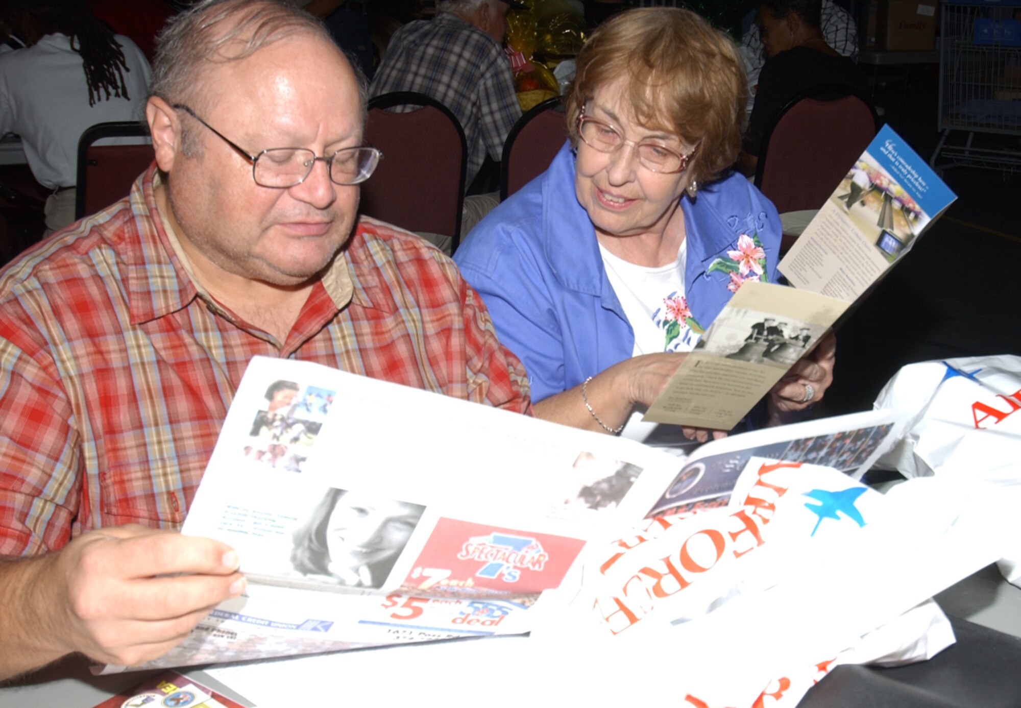 Army retirees Dan and Sandy Reid of Ocean Springs browse through their handouts.  Front-of-the-line service was offered to retirees at the legal, finance and personnel offices and the vehicle registration center at the White Avenue Gate.  Windshield tours to point out locations of key agencies were provided.  (U.S. Air Force photo by Kemberly Groue)