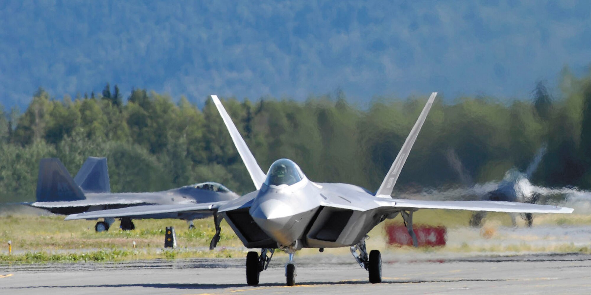 F-22 Raptors taxi following touchdown at Elmendorf Air Force Base, Alaska, during a ceremony marking the aircraft's arrival Aug. 8. Under an associate unit relationship, the regular Air Force's 3rd Wing and Air Force Reserve Command's 477th Fighter Group will fly and maintain the aircraft. The 477th FG is AFRC's first F-22 unit. (Tech. Sgt. Keith Brown)