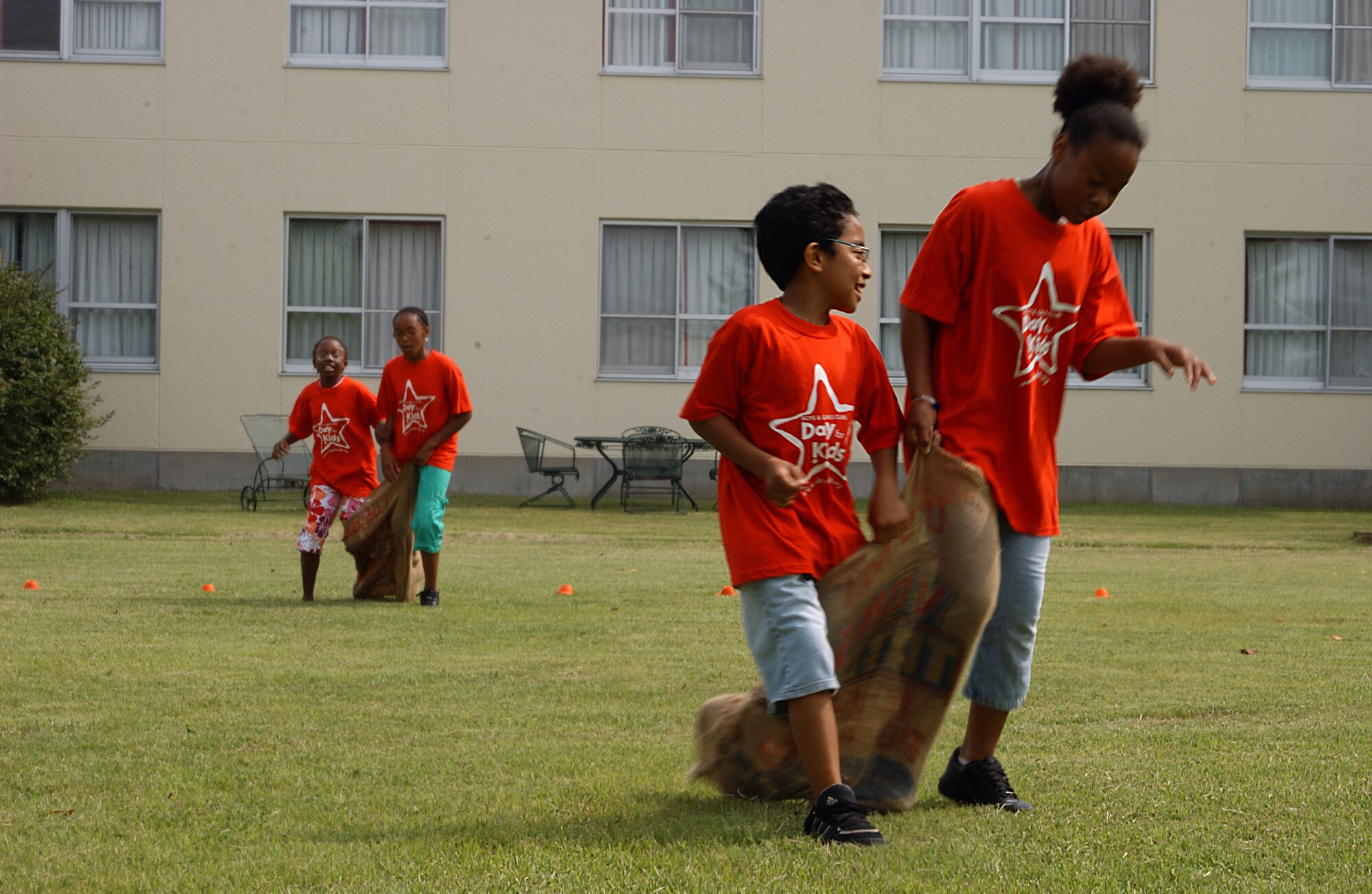 MISAWA AIR BASE, Japan -- Children participate in a three-legged sack race at the annual Boys and Girls Club Day for Kids at the Lunney Youth Center here Sept. 15. The Day for Kids is held to help both children and parents come together for fun, and teach them the importance of being involved. (U.S. Air Force photo by Airman 1st Class Eric Harris)