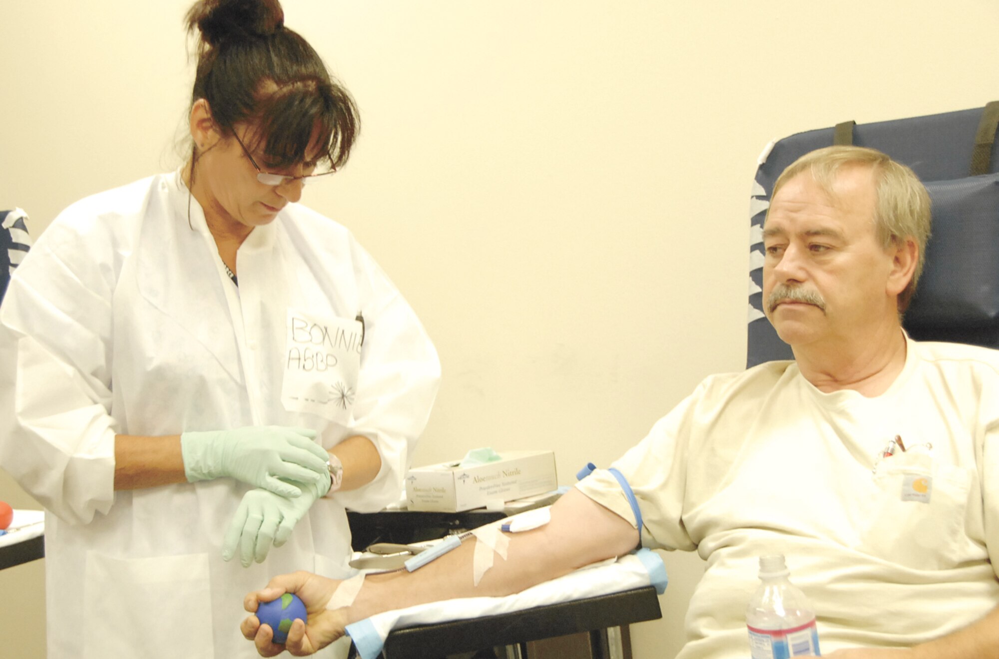 Phlebotomist Bonnie Ferguson checks on donor Roger McCormick during Tuesday's blood drive at Wright Patterson Air Force Base. Skywrighter photo by Christy Webb.