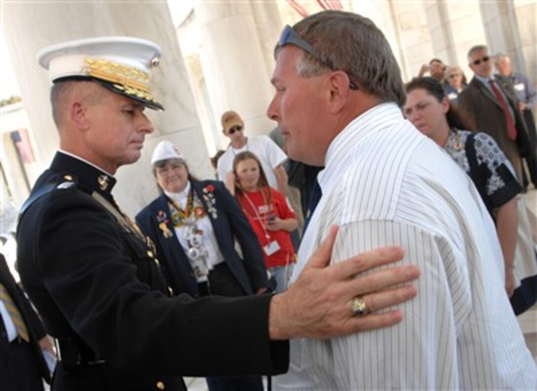 A father who lost a son in combat shares a moment with Chairman of the Joint Chiefs of Staff Gen. Peter Pace, U.S. Marine Corps, at a ceremony at the Tomb of the Unknown Soldier in Arlington, Va., on Sept. 17, 2007.  Pace participated in a wreath laying ceremony with members of Families United-United for a Strong America, which is a non-profit organization whose members have lost a loved one in defense of the nation or who have family members that are currently serving in harms way.  