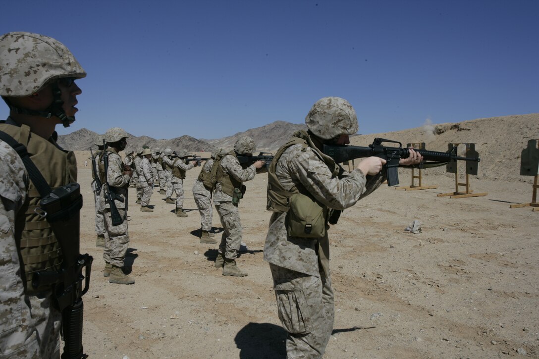 Marines from the Anti-Terrorism Force Protection Platoon wait for the command to fire during a monthly exercise Sept. 19 at the Combat Center Rifle Range.