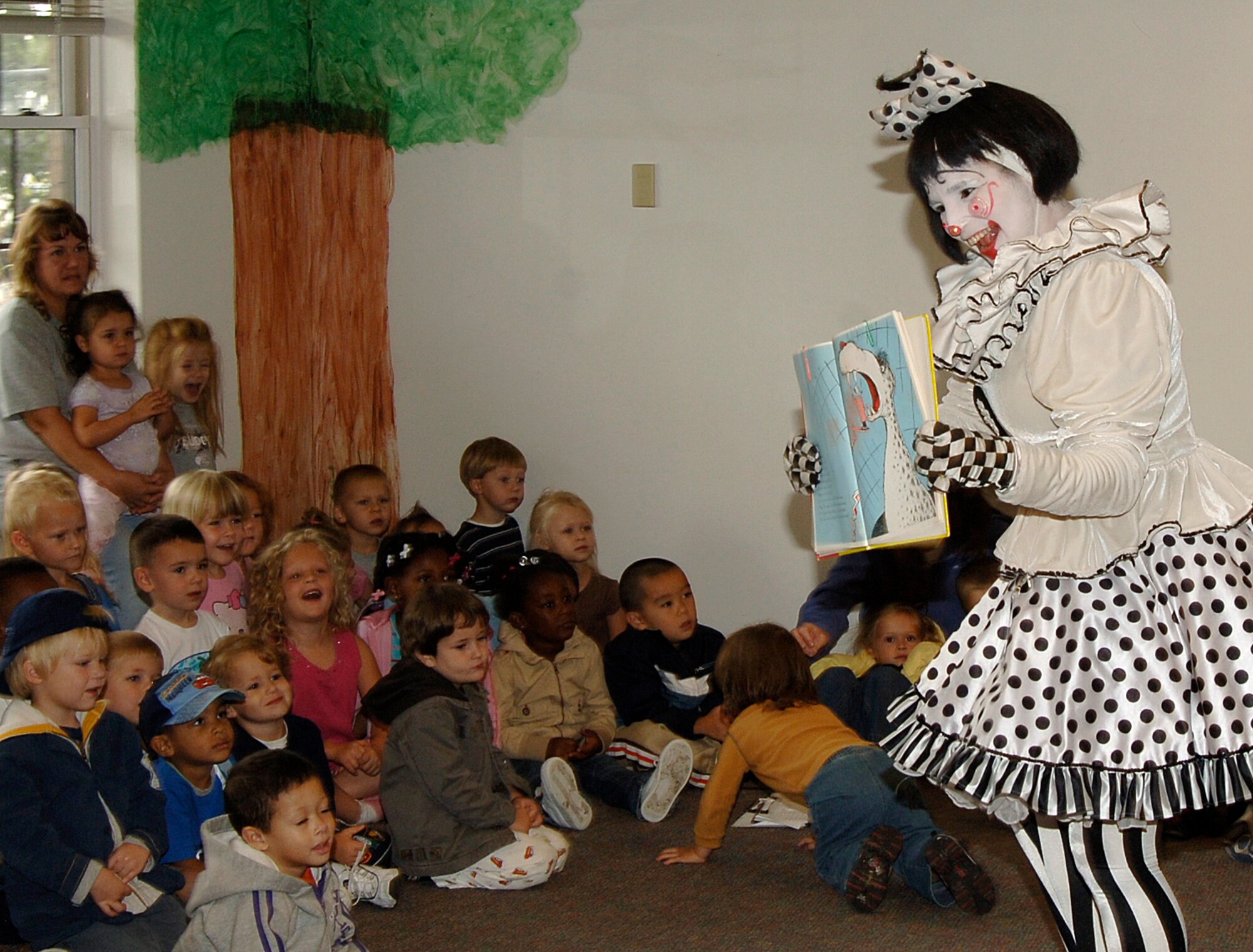 MCCONNELL AIR FORCE BASE, Kan. – Cherie Gregg, a Barnum and Bailey Circus clown, reads a book about the circus to children at the Child Development Center, Sept. 14. (photo by Airman 1st Class Laura Suttles) 