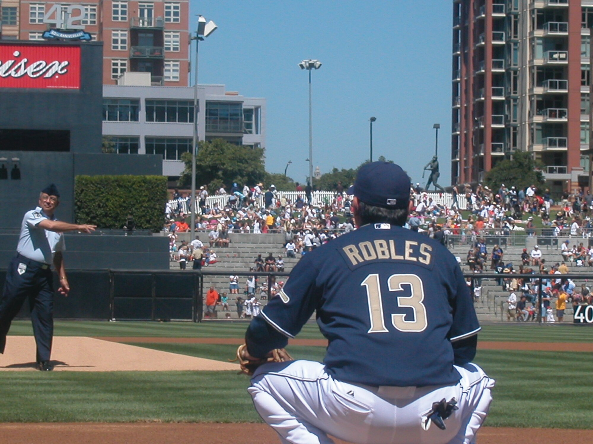 Senior Master Sgt. Frank De Juaregui throws the first pitch of the Padres game Sunday, Mexican Independence Day, to Oscar Robles. (U.S. Air Force photo by Tech. Sgt. Michael Blair)