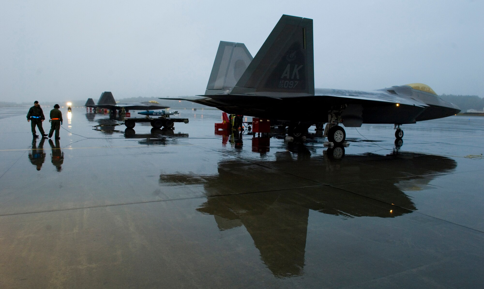 ELMENDORF AIR FORCE BASE, Alaska -- Rain-soaked crew chiefs from the 90th Aircraft Maintenance Unit prepare to launch an F-22A Raptor. (U.S. Air Force Photo by Senior Airman Garrett Hothan)