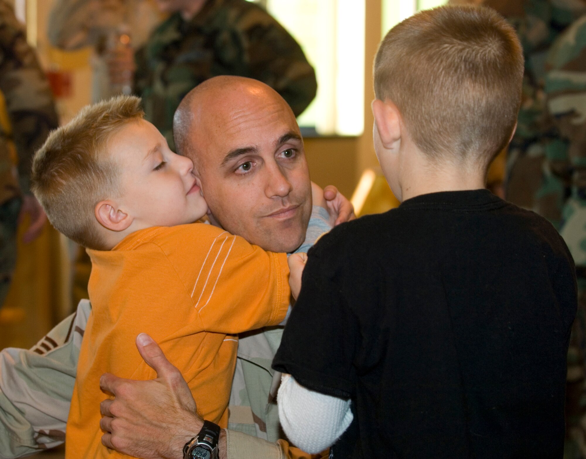 ELMENDORF AIR FORCE BASE, Alaska -- Master Sgt. Noah Wood is welcomed home by his two sons, Dekota and Dylan. More than 40 Airmen assigned to Air Expeditionary Forces 7 and 8, returned home to their families and friends Sept 17.  (U.S. Air Force photo/Senior Airman Garrett Hothan)