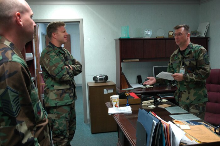 HILL AIR FORCE BASE, Utah-- Senior Master Sgt. Scott Martin, first sergeant for the 388th Equipment Maintenance Squadron, provides a personnel update on on-going squadron issues to Maj. Michael Hammond, commander for the 388 EMS.  (U.S. Air Force photo by Capt. Genieve David)
