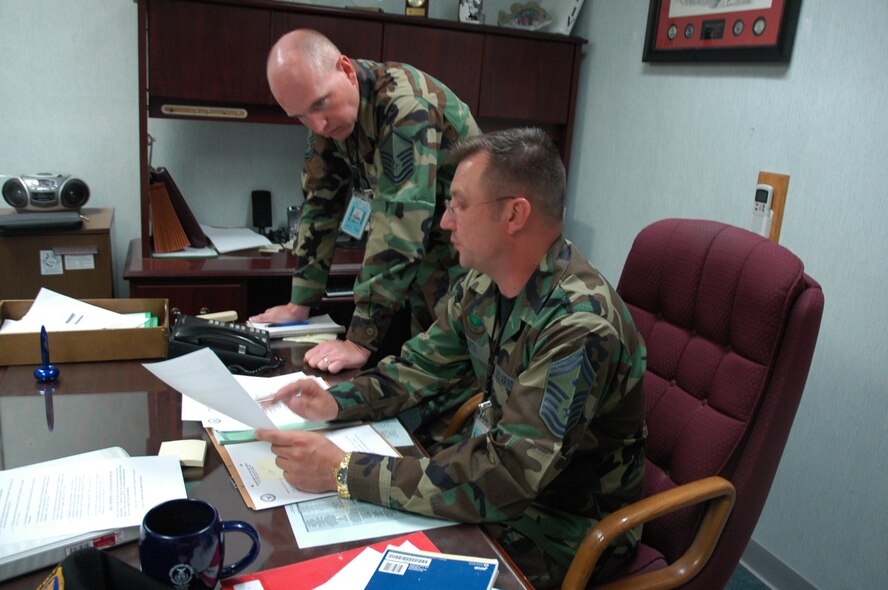 HILL AIR FORCE BASE, Utah-- Senior Master Sgt. Scott Martin, first sergeant for the 388th Equipment Maintenance Squadron, explains to his newest recruit, Master Sgt. Walter Anderson, 388 EMS under-shirt, a proposed course of action to take on a personnel issue.  (U.S. Air Force photo by Capt. Genieve David)