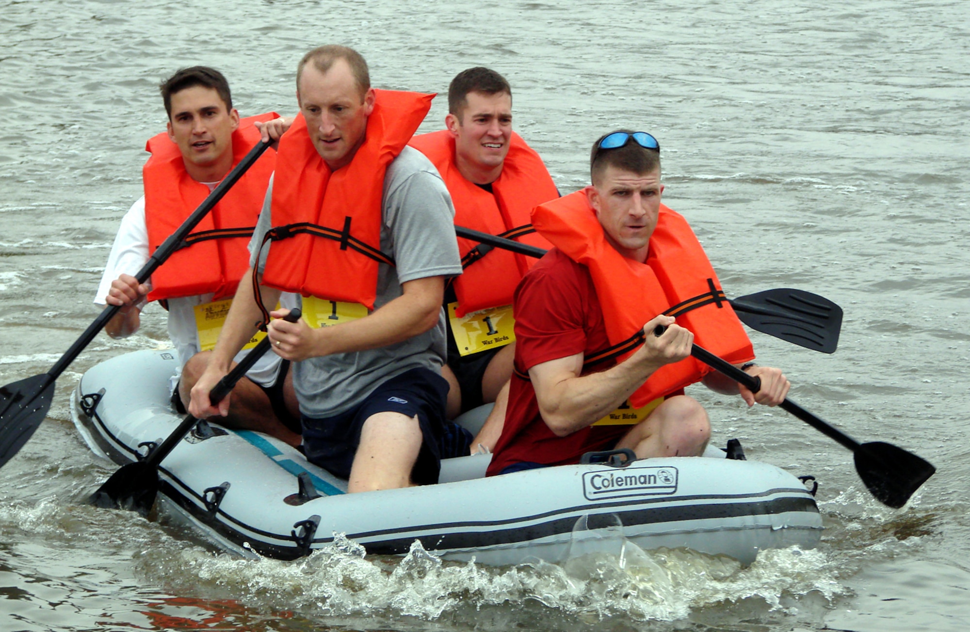 The Warbirds, representing Vance AFB's newest unit, the 3rd Fighter Training Squadron, head for the shore at the end of the 2.4-mile rafting leg of the base's first Adventure Race. The team, from left to right, Brian Gienapp, Will Browne, Todd Dyer and NateThompson, had the day's best time to take the extreme team title. (US Air Force photo/Frank McIntyre)