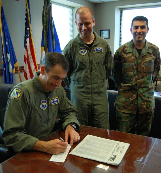 LAUGHLIN AIR FORCE BASE, Texas -- Col. Mike Minahan, 47th Flying Training Wing commander, makes the first donation for Laughlin's Combined Federal Campaign, while CFC project officers Capt. Nathan Cook and 1st Lt. Eric Alonso-Bernal look on. The campaign kicked off Monday and runs through Oct. 26.  Laughlin CFC key workers will be contacting Team XL members during the campaign.  The mission of the CFC is to promote and support philanthropy through a program that is employee focused, cost-efficient, and effective in providing all federal employees the opportunity to improve the quality of life for all.  (U.S. Air Force photo by Airman Sara Csurilla)
