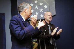 Tech. Sgt. Jeramie Brown salutes Lt. Gen. Frank Klotz, Air Force assistant vice chief of staff after presenting Sergeant Brown with the Purple Heart.  Sergeant Brown was injured during a mortar attack in Iraq in June 28. (US Air Force/Bobby Jones)