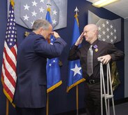 Lt. Gen. Frank Klotz, Air Force assistant vice chief of staff and Tech. Sgt. Jeramie Brown sing The Air Force Song in unsion at the conclusion  of a Purple Heart award ceremony held in his honor Sept. 17. (US Air Force/Bobby Jones)