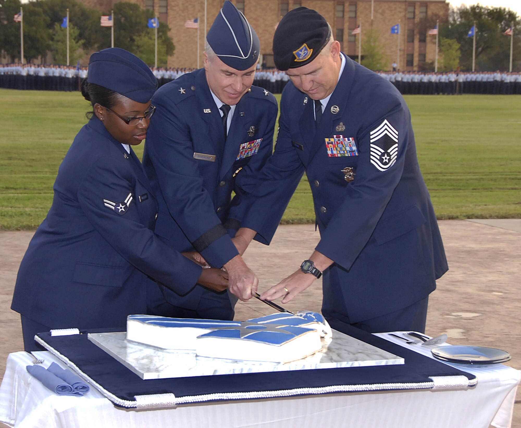 Brig. Gen. Richard Devereaux (center), 82nd Training Wing commander, Chief Master Sgt. Errol Tummings (right) and Airman 1st Class Denise McClease cut a cake to usher in the Air Force's 60th Anniversary Sept. 18 at the base parade grounds. Chief Tummings, from the 366th Training Squadron, and Airman McClease, from the 82nd Mission Support Squadron, represented the oldest and youngest Airmen, respectively, at the ceremony. (U.S. Air Force photo/Harry Tonemah)
