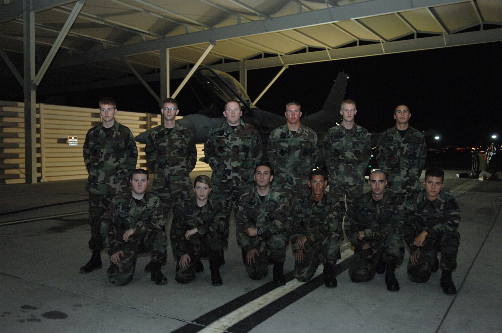 (Top) Airman Mark Fox, Senior Airman Brandon Patterson, Staff Sgt. John Harper, Airman 1st Class Raymond LeBlanc, Airman 1st Class Zachariah Brown, Senior Airman Cole Medina (Bottom) Senior Airman Anthony Ross, Airman 1st Class Holly Popowitch, Airman 1st Class Gustavo Cifuentes, Staff Sgt. Michael Deason, Staff Sgt. Mark Krok, and Airman 1st Class Ryan Wooky of the 57th Maintenance Group came together to replace throttle cables in 12 disabled F-16s restoring the aircraft to full operational status in five days between Aug. 24 and Aug. 29. (U.S. Air Force photo by Senior Airman Larry Reid)